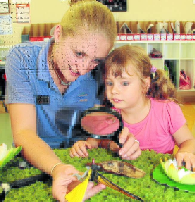 LEARNING FOR LIFE: Yarrawong Children’s Centre carer Demelza Pringle teaches Gretal Sobotta  about insects. 			           Photo: JACK KEMP 0115jkchildcare3
