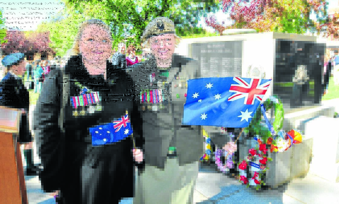 MARK OF RESPECT: Amanda Cullen and Sam Hugget were among a growing number of young people at Anzac Day services across Orange yesterday. Photo: JUDE KEOGH    0425anzac67