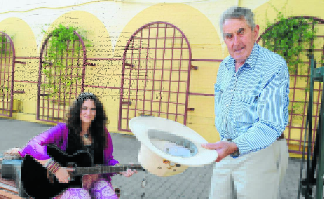 A DOLLAR FOR A SONG: Songstress Alix Riley was one of the first to sign up as a busker at Orange's newest festival next month. She is pictured with busking co-ordinator David Williams. Photo: STEVE GOSCH 					          0113sgbusk2