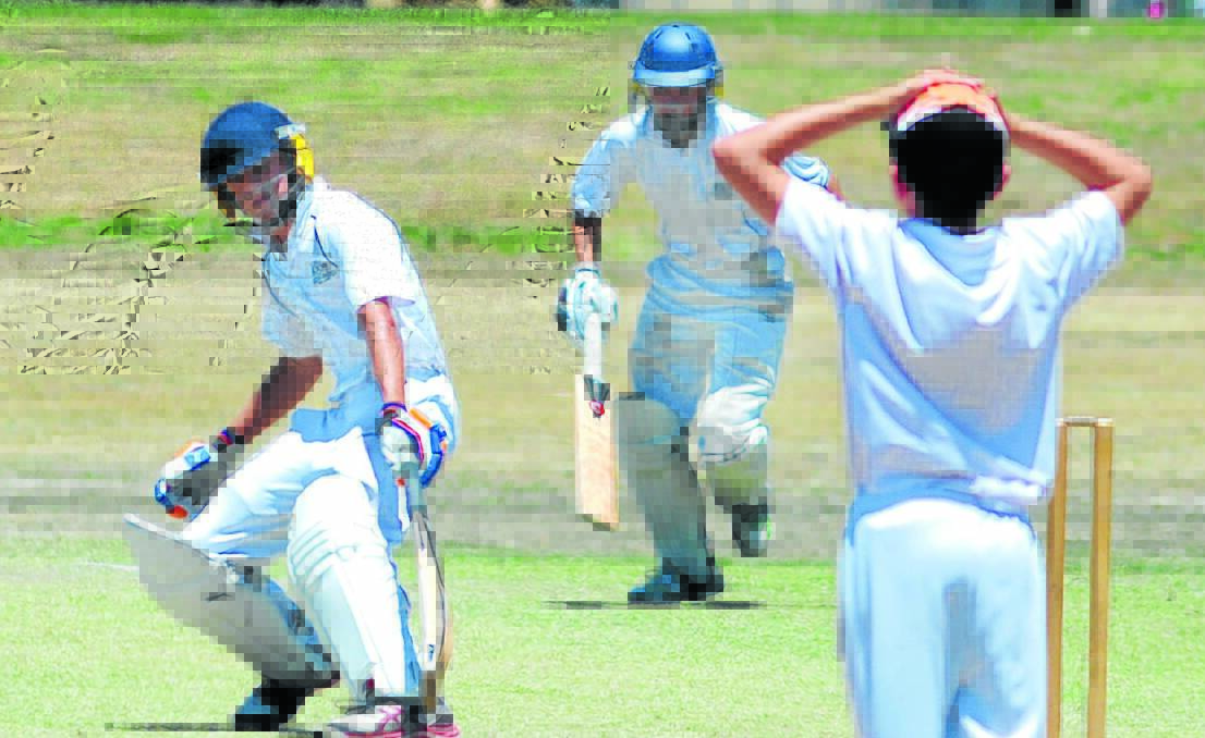 QUICK SINGLE: Keiran Lindsay and Josh Kitchenor scamper off for a run in the Western NSW Junior Cricket Carnivals in Orange last season. A record number of entries will be on hand in 2014. Photo: STEVE GOSCH                                                       0110sgcrick2