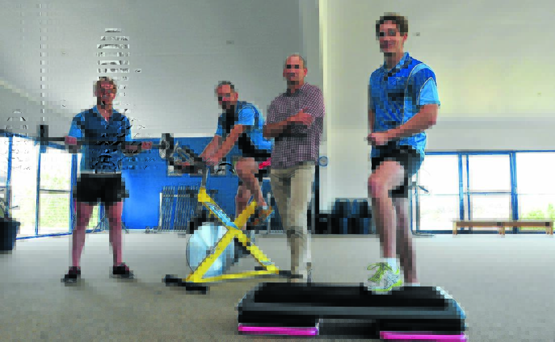 TAKE A STEP UP: Dr James Wickham (second from right) with fitness study participants at Integra Health Club Brendan Wotton, Anthony Ellison and Andrew Peterson. Photo: JUDE KEOGH    1204gymstep1