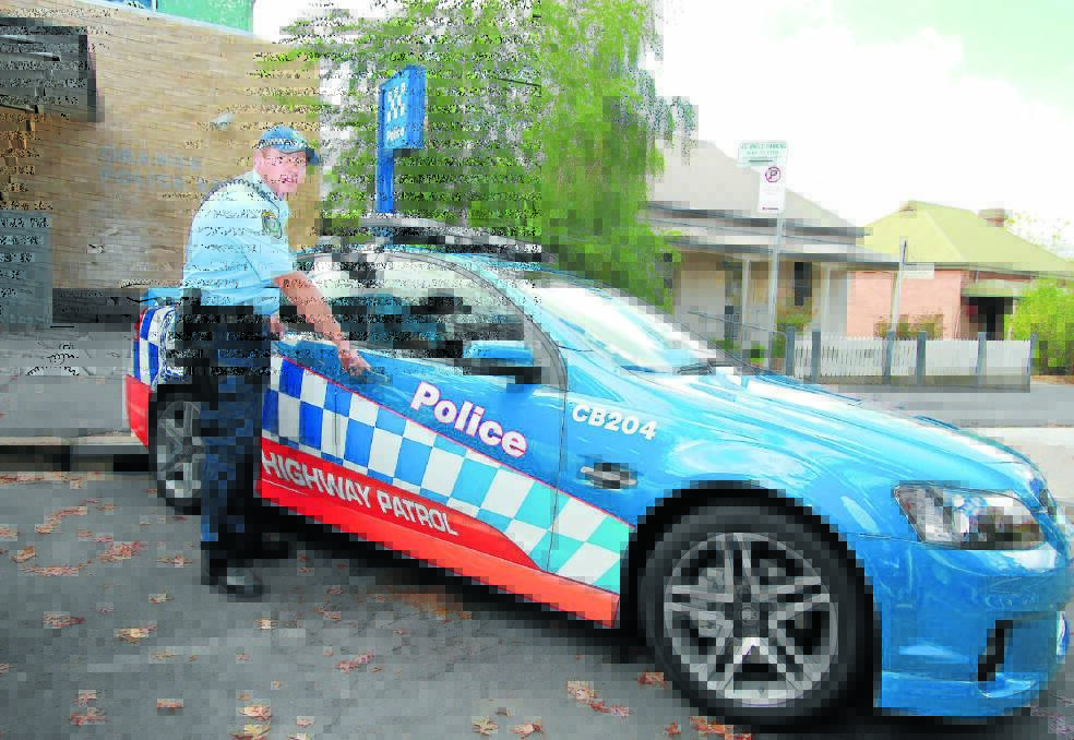 OVERTLY COVERT: Senior Constable Michael Golding with the new highway patrol vehicle.  Photo: JEFF DEATH 0416jdpolicecar05