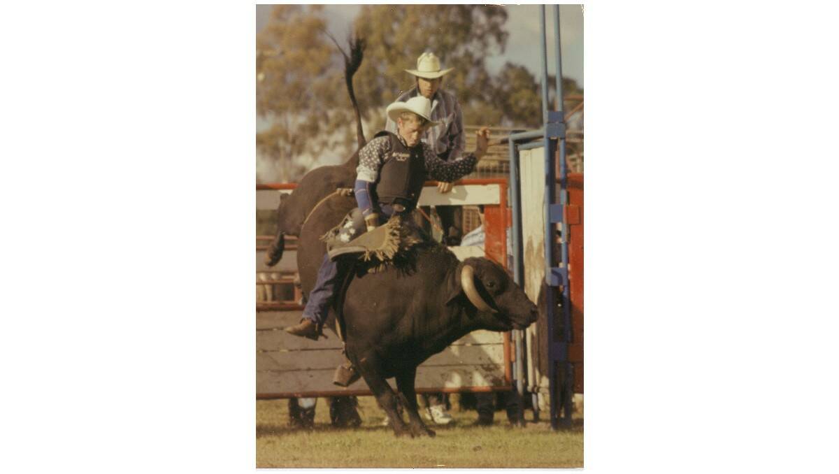 ADRENALIN RUSH: Cowboy Ross McCarthy in action with Stinkie the bull at a rodeo in Cowra in 1996. He will saddle up next month as a competitor in the Orange Rodeo. Photo: COWRA PHOTOGRAPHICS