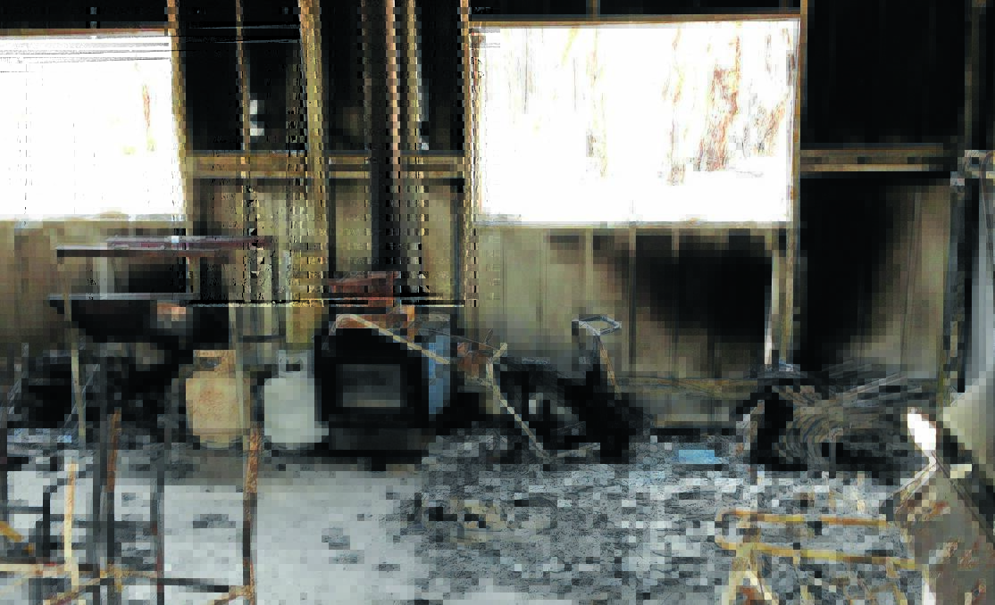 A FIERY END: The fire ravaged clubhouse at the Wattle Flat golf course. 011314arson1