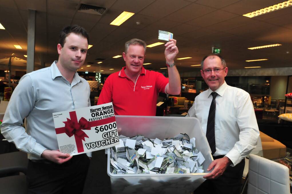 FESTIVE FUN: Harvey Norman Orange franchisees Kurt Rooke and Steve Munro with Central Western Daily managing editor Tony Rhead drew one lucky winner for the Festive Frenzy promotion yesterday. 			  Photo: JUDE KEOGH 1220harvey 1 to 3