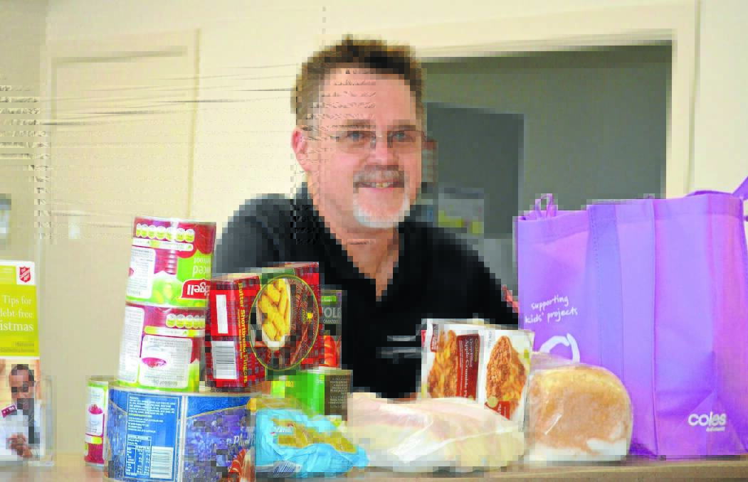 CONCERNED: Salvation Army Captain Greg Saunders with some of the items the charity hands out to people on Newstart. 										       Photo: NICOLE KUTER 0102nksalvo1 