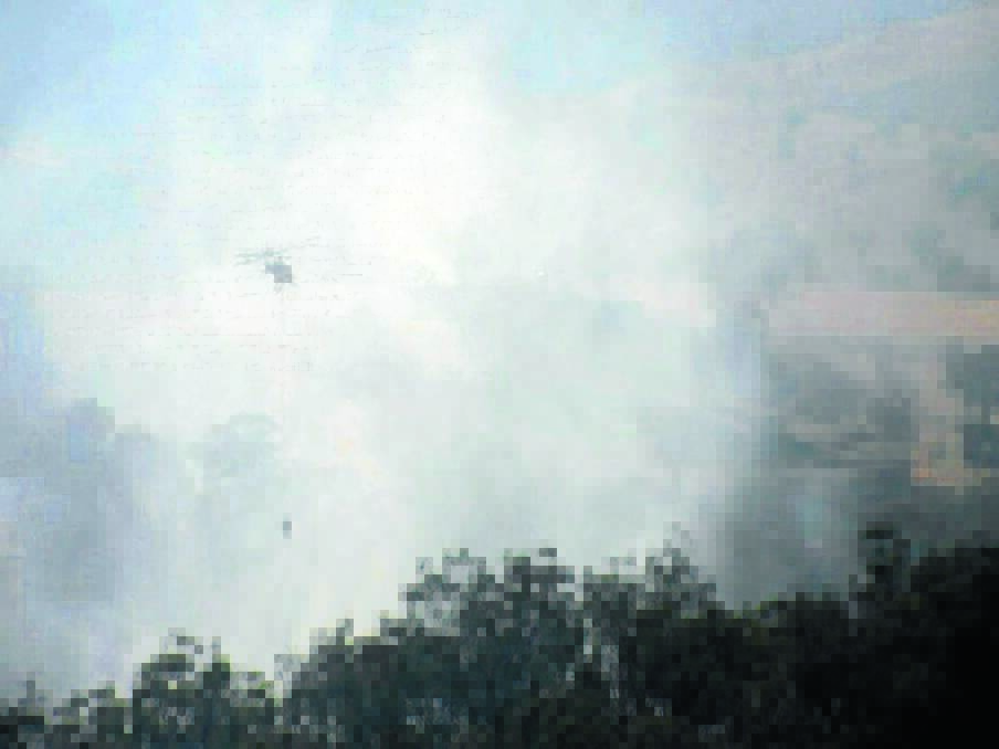 HELP FROM ABOVE: There were seven helicopters waterbombing the fire at Long Point yesterday, which is burning in inaccessible terrain. 