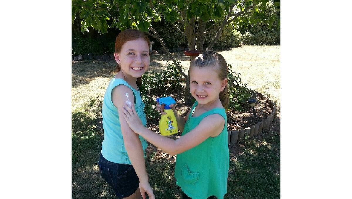 SUN SAFE: Emily and Tegan Sammut make sure they are covered in sunscreen with temperatures expected to hit 34 before Christmas Eve. Photo: CONTRIBUTED