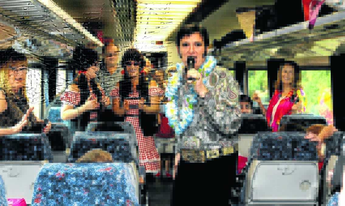 IT'S CARNIVAL TIME: Tribute artist Carmine Cimilio performs on the Elvis Express during a stopover in Orange. Photo: STEVE GOSCH 0109sgelvis6
