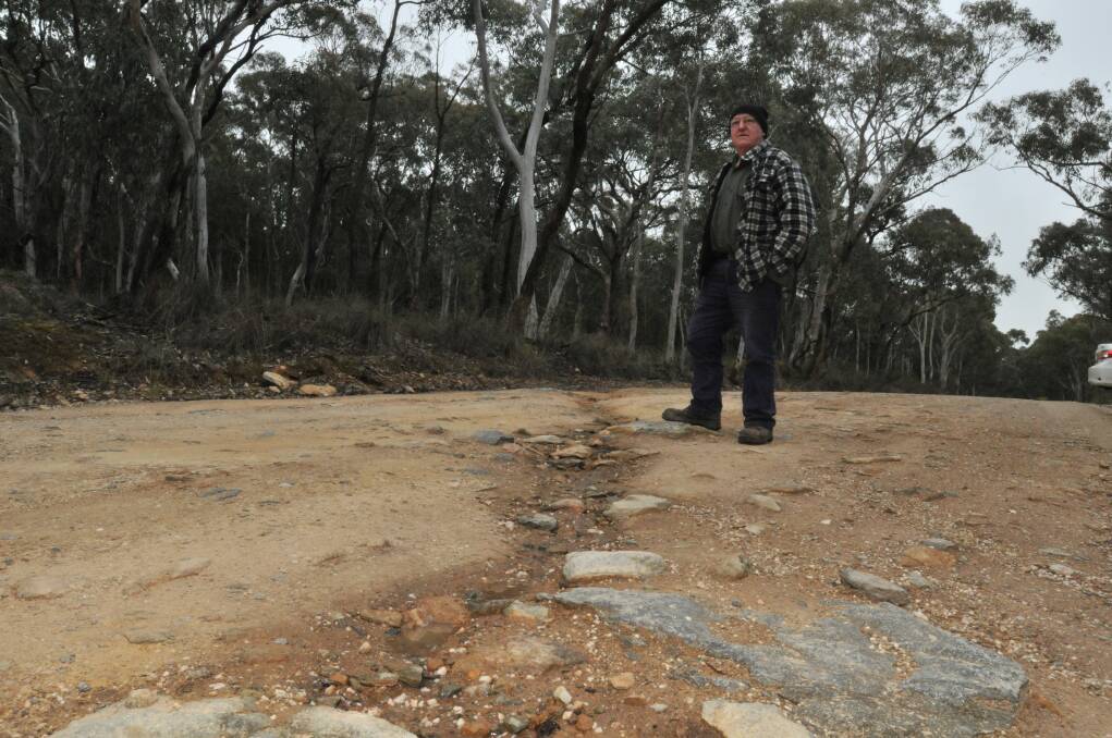 FIX THE FISSURES: Ophir resident Nick Spicer is not happy with the condition of Lookout Road. Photo: JUDE KEOGH  0828lookoutrd1