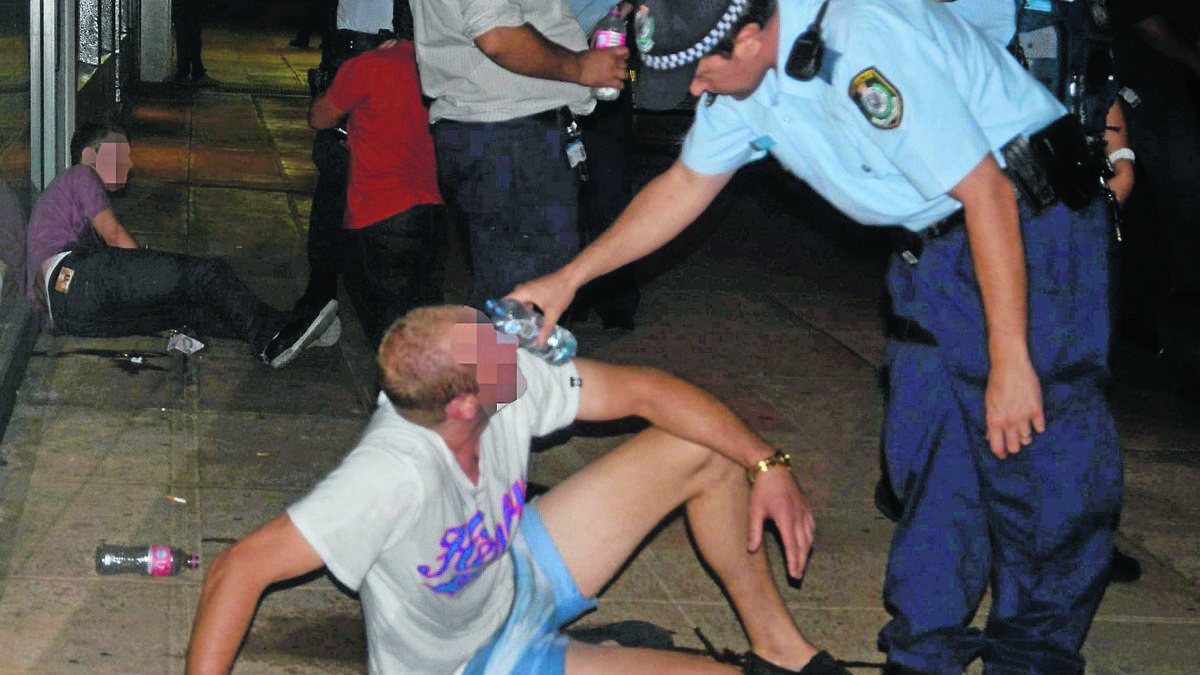 VIOLENT SCENE: A young man has water poured into his eyes by police after capsicum spray was used to break up a fight outside the Occidental Hotel early on Sunday morning. Photo: NICOLE KUTER 						               0211nkoxox17