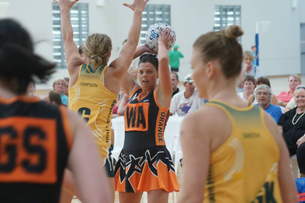 THEY'RE BACK: Orange's Petrina Allen looks to get past the Baulkham Hills defence in this yeat's HeartKids Cup match. Photo: MARK LOGAN                                                        0211mlnetball9