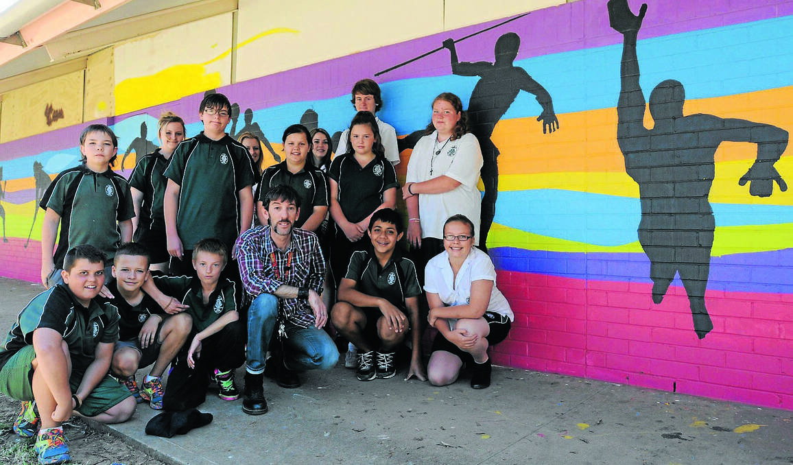 ORANGE: THE grounds of the Canobolas Rural Technology High School may be decades old, but they are in the process of getting an “uplift” thanks to the collaboration of teachers and students. Students (front) Joel Reid, Brendon Ditmar, Jerome Barnes, visual arts teacher Matt Caulfield, Daniel Mateo and Jess Heywood, (middle) Jesse Kelly, Harmon Whan, Sharleene Risby, Hayley Rothnie, Caitlin McGregor (back) Emily Marshall, Kath Howarth, Tamara Palmer and Jack Mahoney joined forces to brighten up their school. Photo: STEVE GOSCH 1128sgmural1