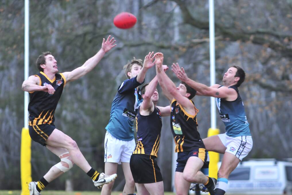 ONE IN, ALL IN: Orange and Bathurst players contesting a bounce, published on Monday, July 1. Photo: JUDE KEOGH