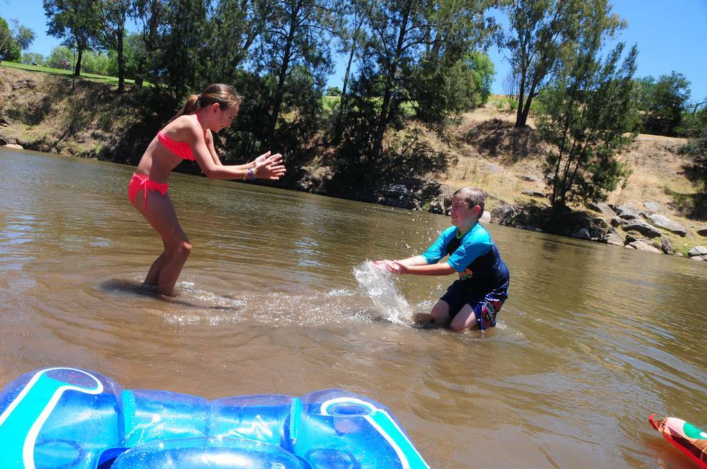 DUBBO: NSW Police and Emergency Services Minister Michael Gallacher has urged people to be water smart during this holiday period. Tahlana Griffiths and Joshua Lees frolic in the river at Sandy Beach as it heats up this summer. Photo: CHERYL BURKE