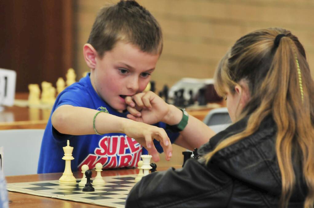 YOUR MOVE: Alexander Davis playing chess. Photo: JUDE KEOGH