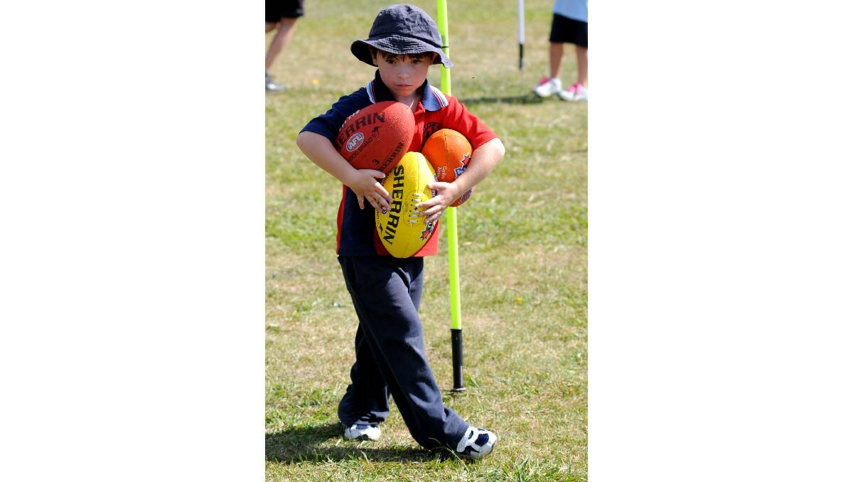 HARLEY THE HELPER: Harley Gilbert, of Bowen Public School Yr1J, helps out during an Aus Kick clinic in Orange.