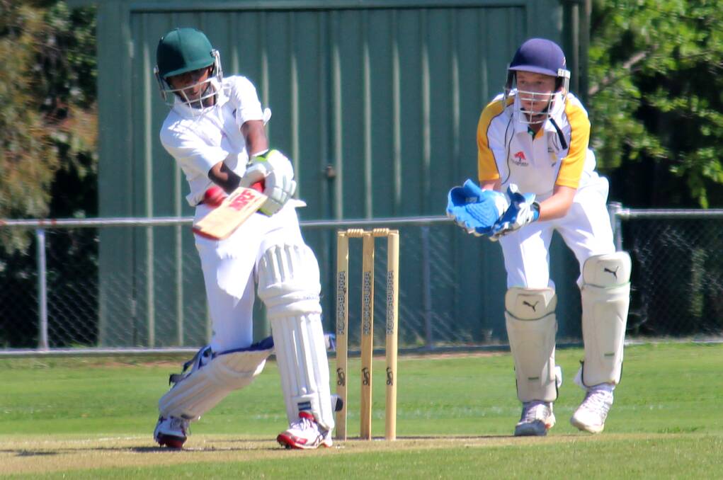 ACT Under Gold's Kris Weereratne hits out as South Coast wicketkeeper Blake Harrison watches on at Riawena Oval on Wednesday. Photo: MELISE COLEMAN