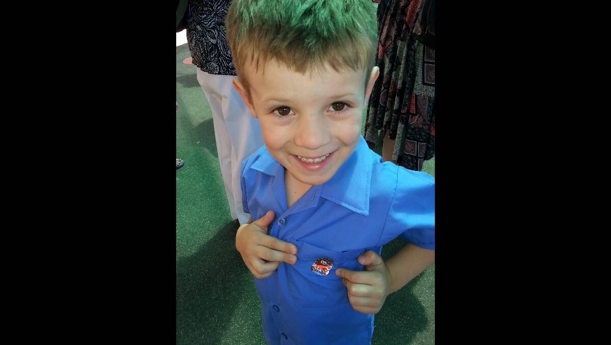 Max Fisher showing of his first sticker at the end of his first day of kindergarten at Catherine McAuley Catholic Primary School. Photo: BELINDA FISHER