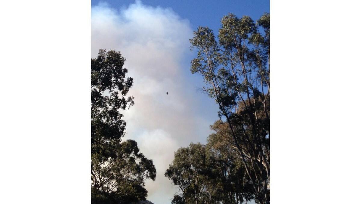 FIGHTING THE FIRE: Images of the blaze that has burnt out over 150 hectares at Mullion Creek, north of Orange. Photo: LEARNE SPICER