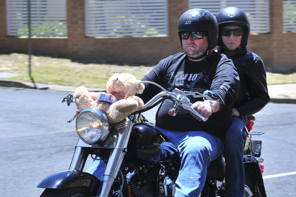 BIKING IN HAPPINESS: Tim and Joel Woods on the annual toy run. Photo: JUDE KEOGH