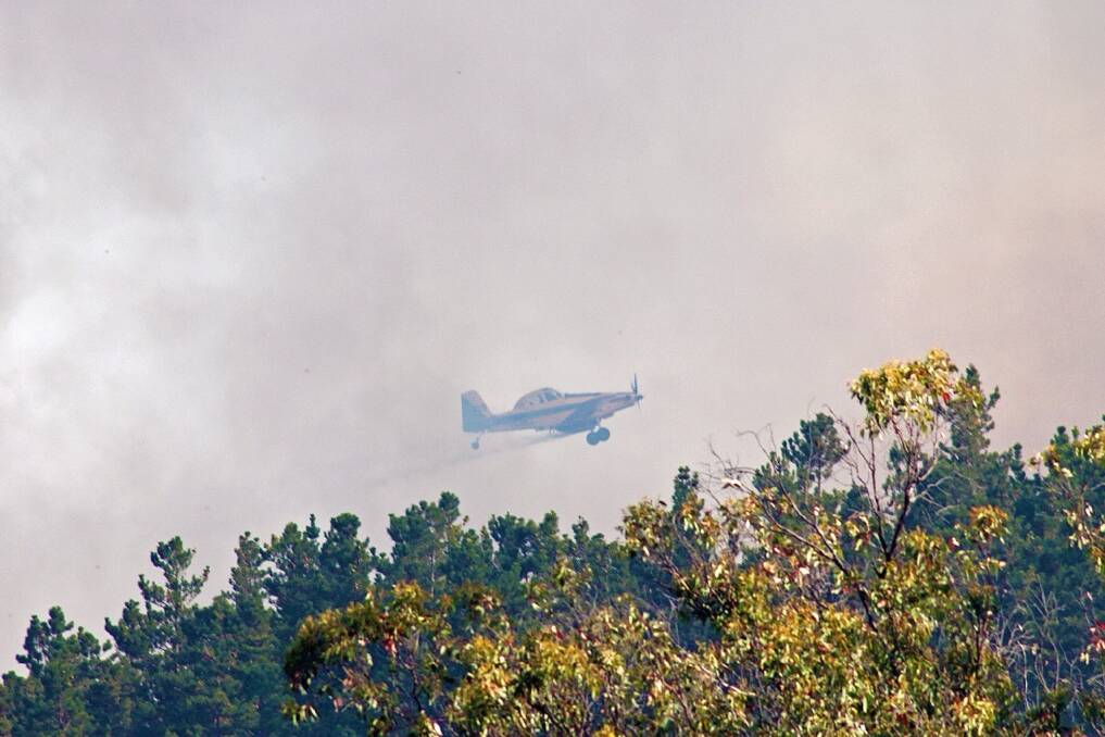 FIGHTING THE FIRE: Images of the blaze that has burnt out over 150 hectares at Mullion Creek, north of Orange. Photo: ADAM ROBERTS