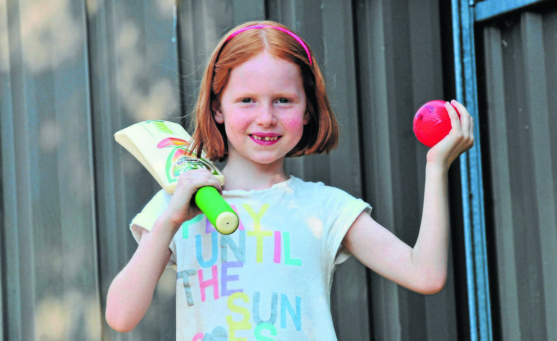 ORANGE: Kaylee Grenfell is one of a host of young kids taking up cricket this season after the success of Michael Clarke's Australian team. Photo: JUDE KEOGH 0107kidscricket2