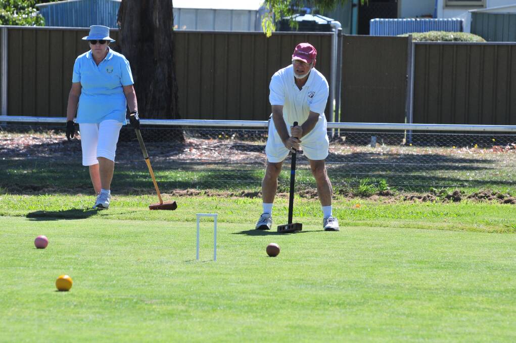 THIS IS HOW IT'S DONE: Bernice Gibson (Manly) shows Greg Deakin (Killara) the way.