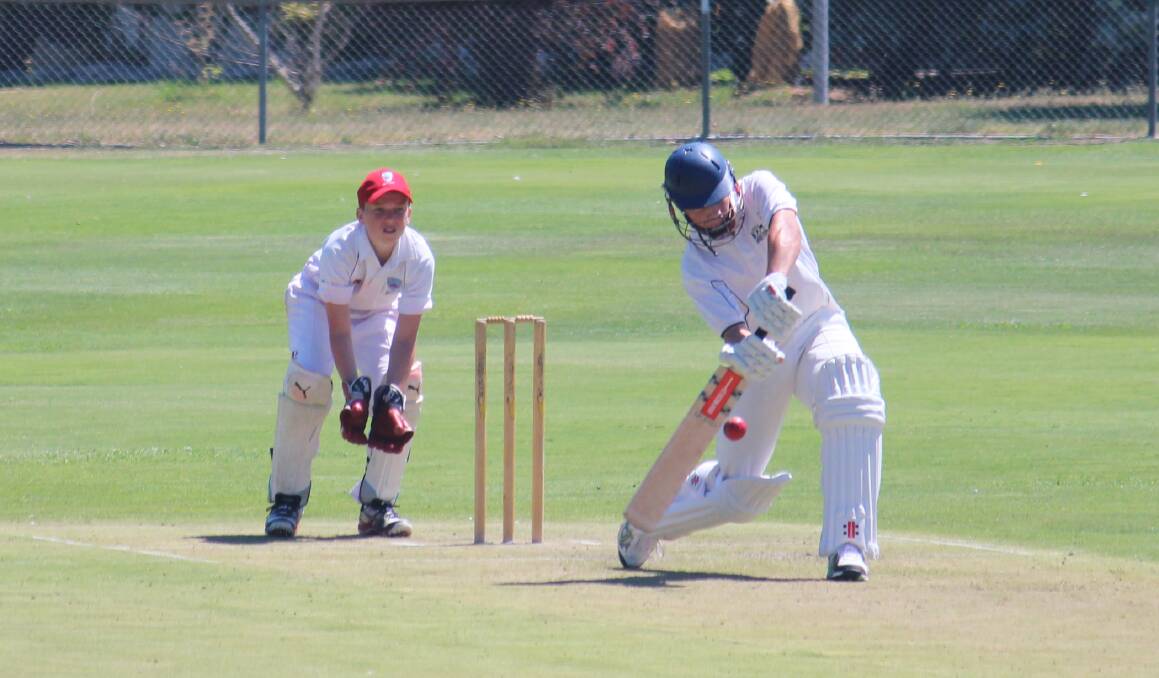 Mitchell's Michael Hannelly hits out against Illawarra as wicketkeeper Noah Butler waits at Riawena Oval on Tuesday. Photo: MELISE COLEMAN
