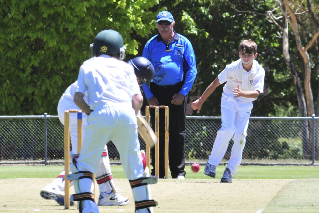 ACT Under 12s Sam Frost bowls against North Shore at Riawena Oval on Monday. Photo: JUDE KEOGH