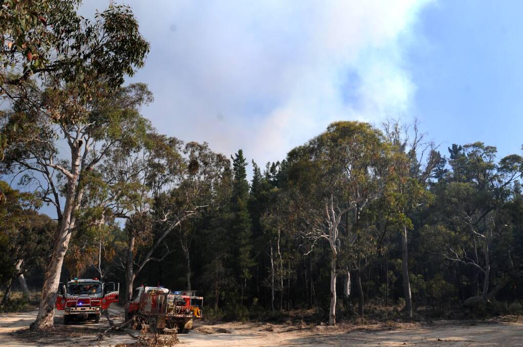 FIGHTING THE FIRE: Images of the blaze that has burnt out over 150 hectares at Mullion Creek, north of Orange. Photo: STEVE GOSCH