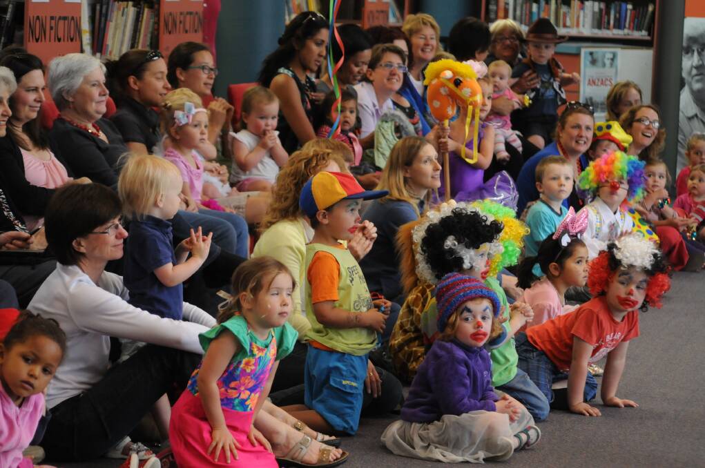 PAYING ATTENTION: The Storytime pre-schoolers give their devoted attention to Orange High School's circus troope at the library on Tuesday. Photo: STEVE GOSCH