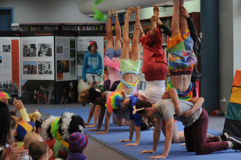 AMAZINGLY ACROBATIC: Orange High School's circus troope struts their stuff at the library on Tuesday. Photo: STEVE GOSCH