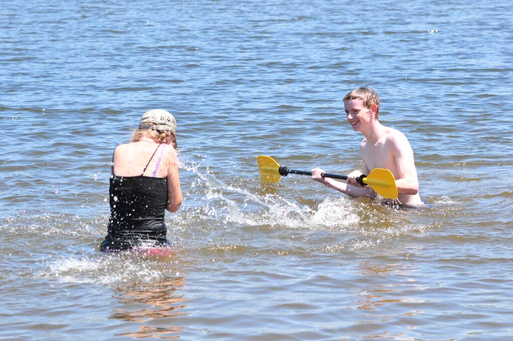 LAKE: Myles Thomas splashes his mum Julie Poynter. Photo: JUDE KEOGH