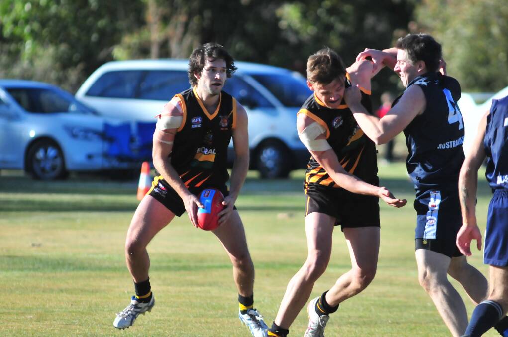 HELPING OUT: Tigers Josh Bubnich is given some protection by Orange ruckman Jack Rogers.