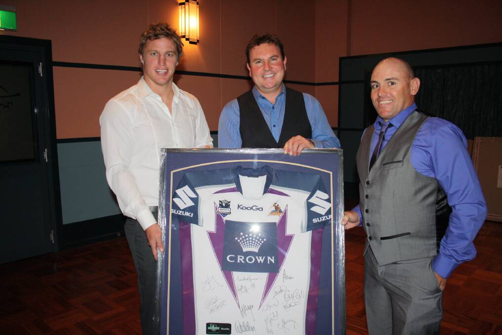 March 2 - Former NRL player Brett Finch (left) and Steve Morgan (right) with Lee Mackenzie (centre) who had the winning bid for the signed and framed 2012 premiership Storm jersey at the Morgan Brothers Ball on Saturday. Photo: MICHELLE COOK 0302mcmorgan2