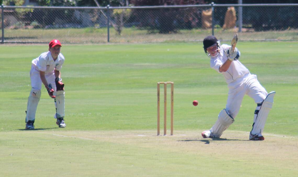 Mitchell's Ryan Peacock smashes one as Illawarra wicketkeeper Noah Butler watches on in their sides' game at Riawena Oval on Tuesday. Photo: MELISE COLEMAN