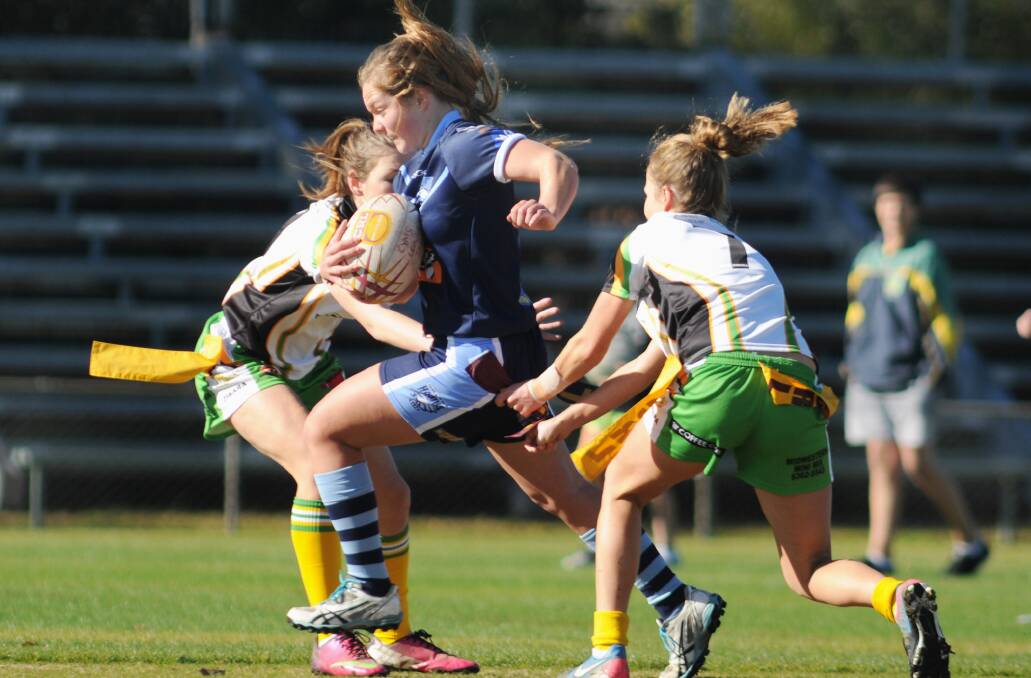 SHE'S THROUGH: Hawks league tag runner Haley Butcherine tries to slice through the CYMS tagers.
