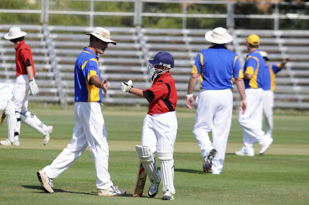 WELL DONE MATE: Paul Murphy congratulates Ryan Manning on his innings.
