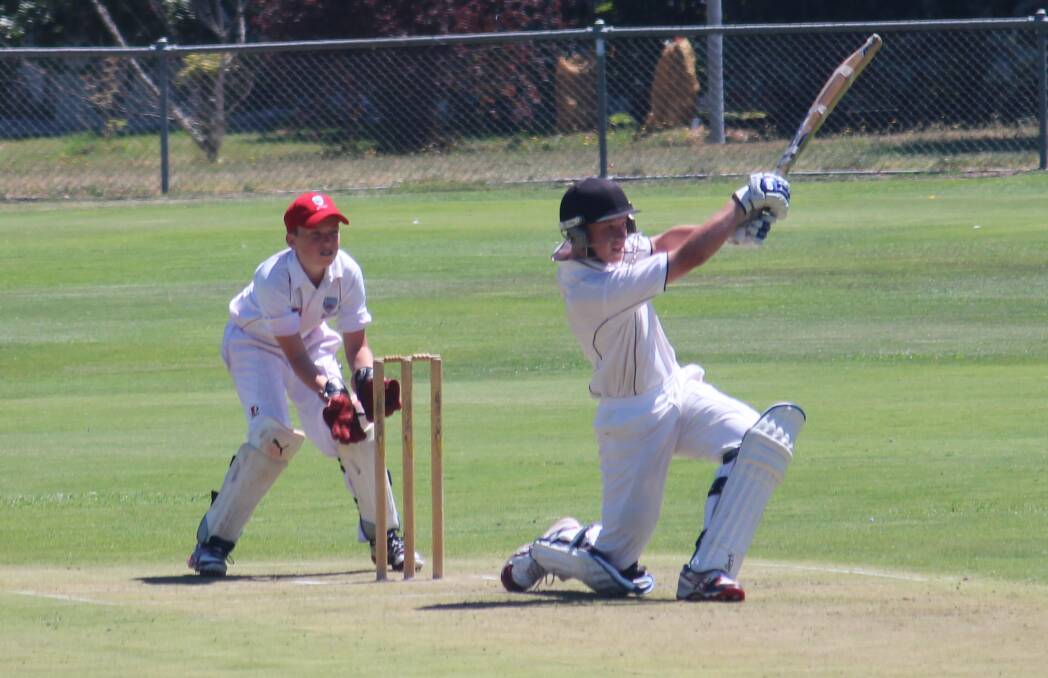 Mitchell's Ryan Peacock smashes one as Illawarra wicketkeeper Noah Butler watches on in their sides' game at Riawena Oval on Tuesday. Photo: MELISE COLEMAN
