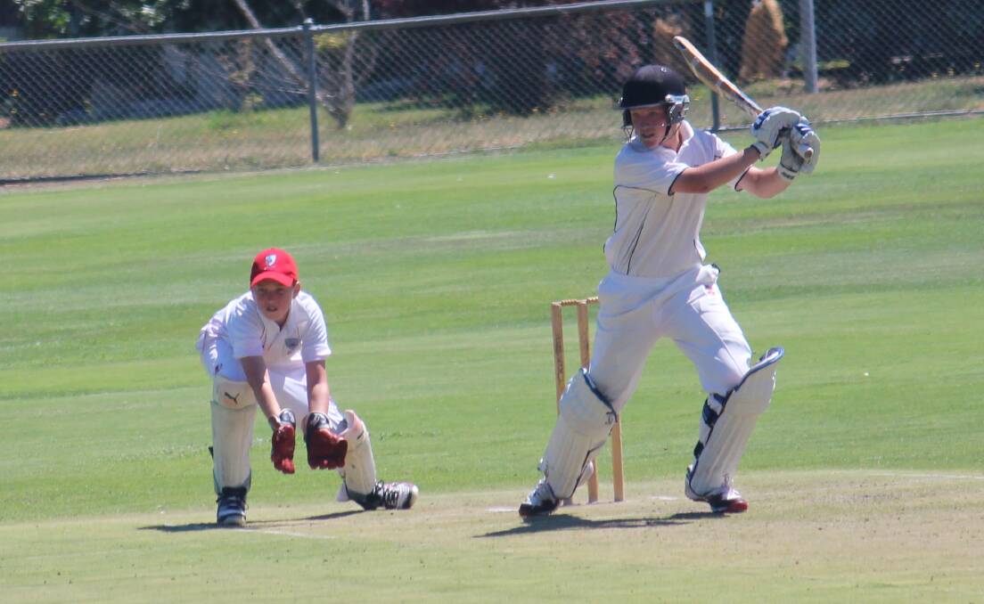 Mitchell's Ryan Peacock drives off the back foot through the covers as Illawarra wicketkeeper Noah Butler watches on in their sides' game at Riawena Oval on Tuesday. Photo: MELISE COLEMAN