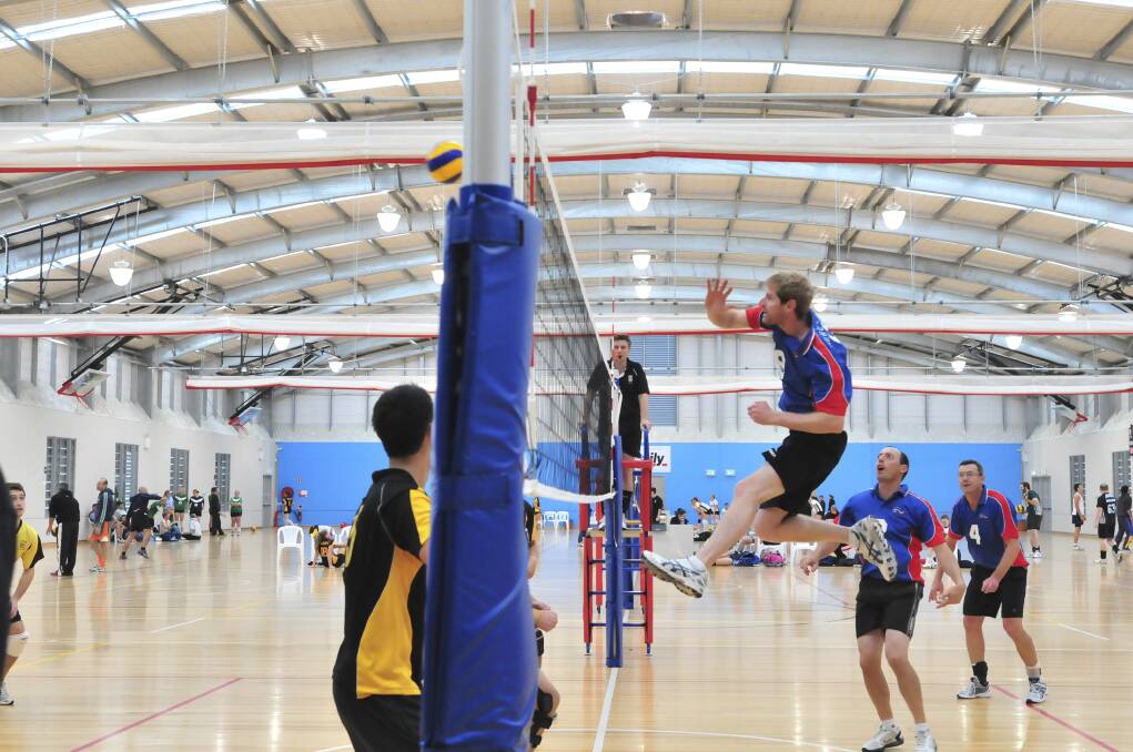 HIGH TIME: Evan James of Newcastle gets airborne during the state volleyball championships. Photo: JUDE KEOGH