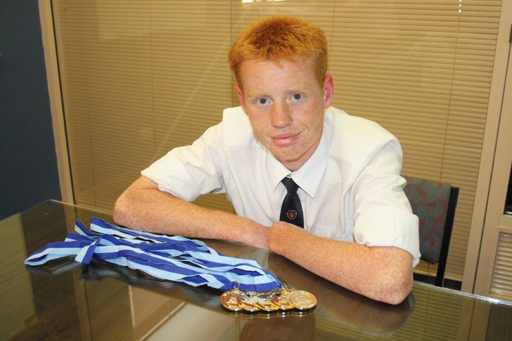 GOOD HAUL: Jets Swim Club's Will Baker shows off the spoils from an impressive meet.