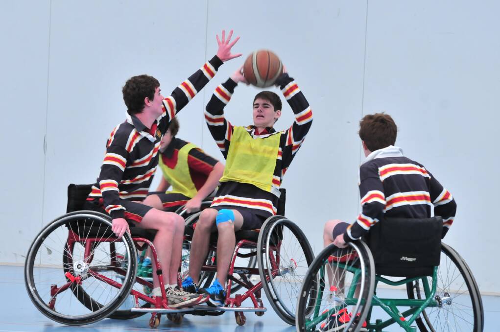 HOLDING COURT: James Sheahan Year 9 student Blake Mileto took to the court on Wednesday in a game of wheelchair basketball under the instruction of Wheelchair Sports NSW Roadshow instructor John Wade. Photo: JUDE KEOGH