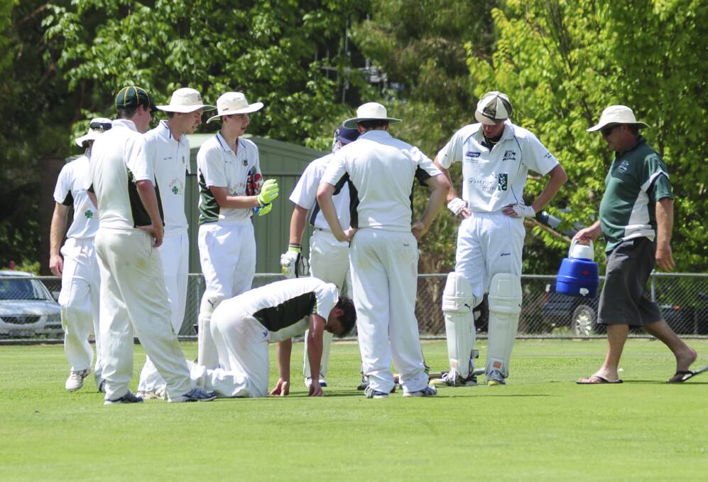 GET DOWN: CYMS' all-rounder Josh Sands shows the wares of a stinking hot day.