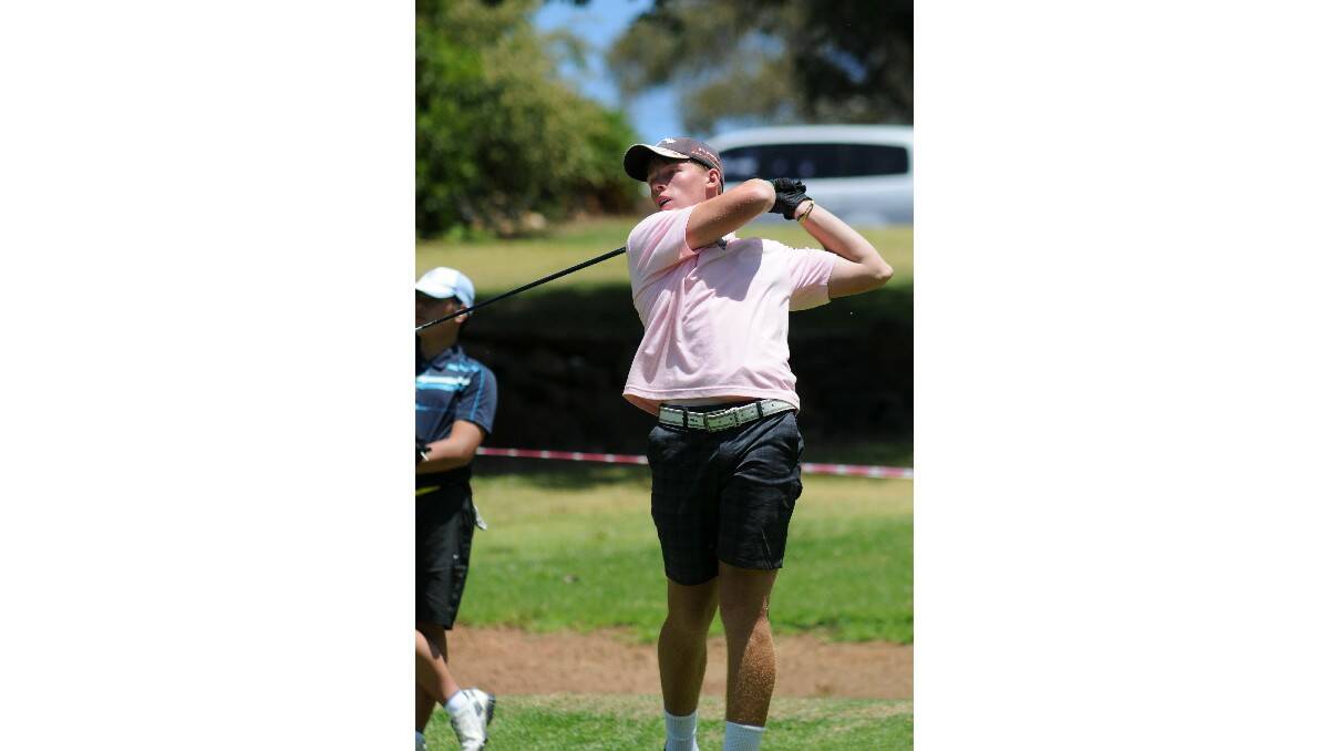 GOLF: Josh Vale watches his drive in the Wentworth Junior Classic. Photo: STEVE GOSCH