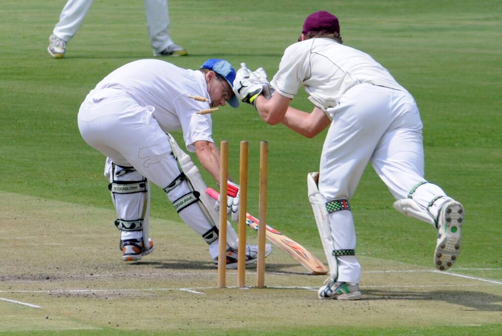 Kinross batsman Andrew Litchfield struggles to make his ground as Cavaliers' keeper Matt Corben removes the bails in their ODCA first grade game at Riawena Oval on Saturday. Photo: STEVE GOSCH
