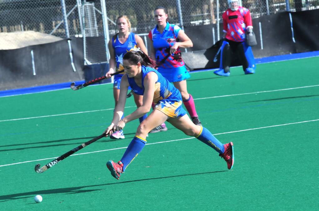 STRETCH: Leanne Kennewell attacks the ball for Ex-Services.