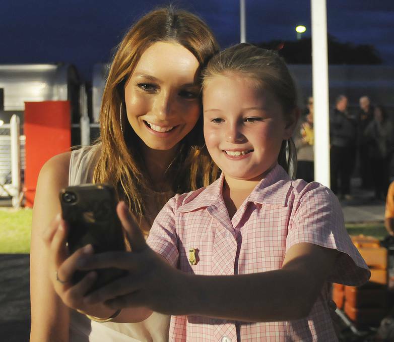 BATHURST: Ricki-Lee Coulter poses with the Assumption School student Sophie Fitzgerald (nine) after the concert at Bathurst Railway Station on Wednesday night. Photos: CHRIS SEABROOK 120413cricki15