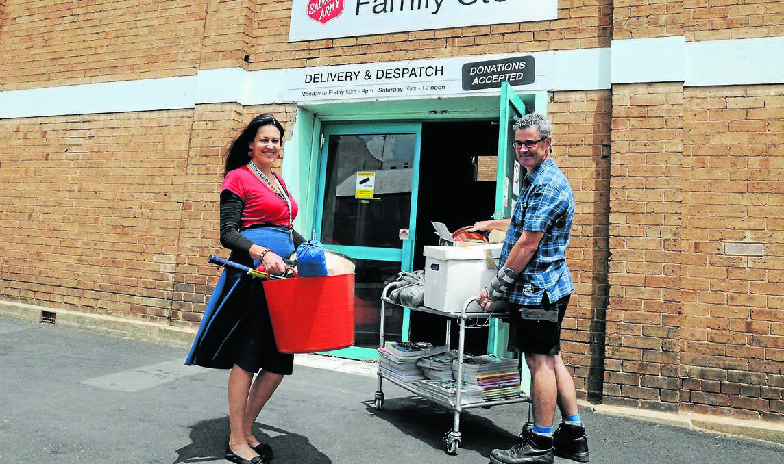 ORANGE: The Salvation Army Family Store retail leading hand Leanne McCulloch and store supervisor Glenn Byrne encourage people to drop donations at the Peisley Street entrance to the store rather than leave them on the footpath next to the donation bins. Photo: STEVE GOSCH 0108sgsalvos2